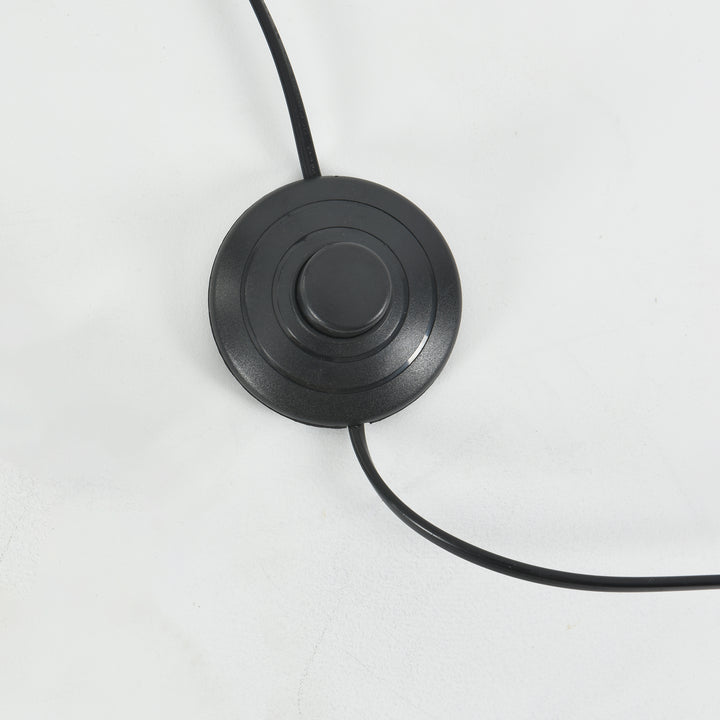 Close-up of the Candied Glass Floor Lamp’s round black foot switch and power cord.