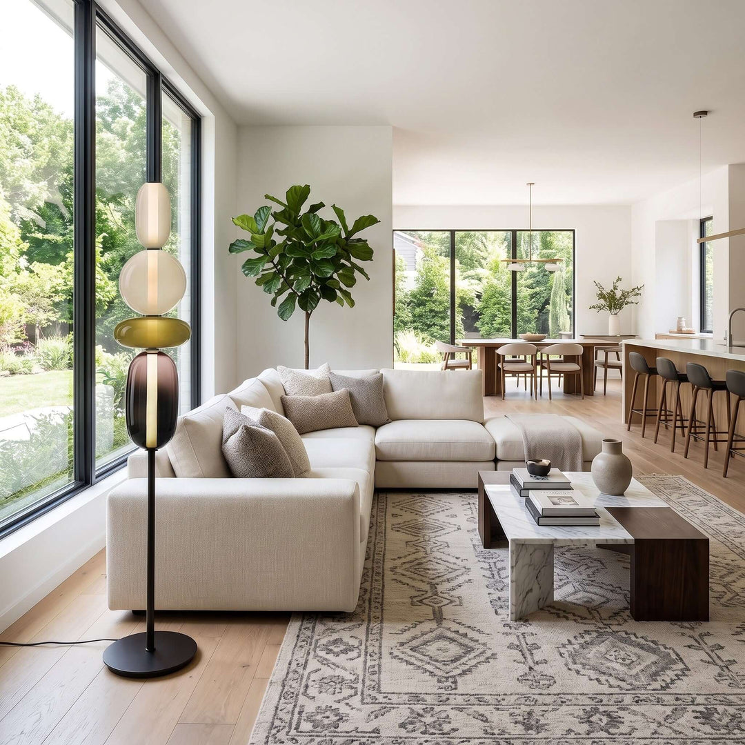 Candied green glass floor lamp beside a white sectional sofa in a bright open-plan living room.