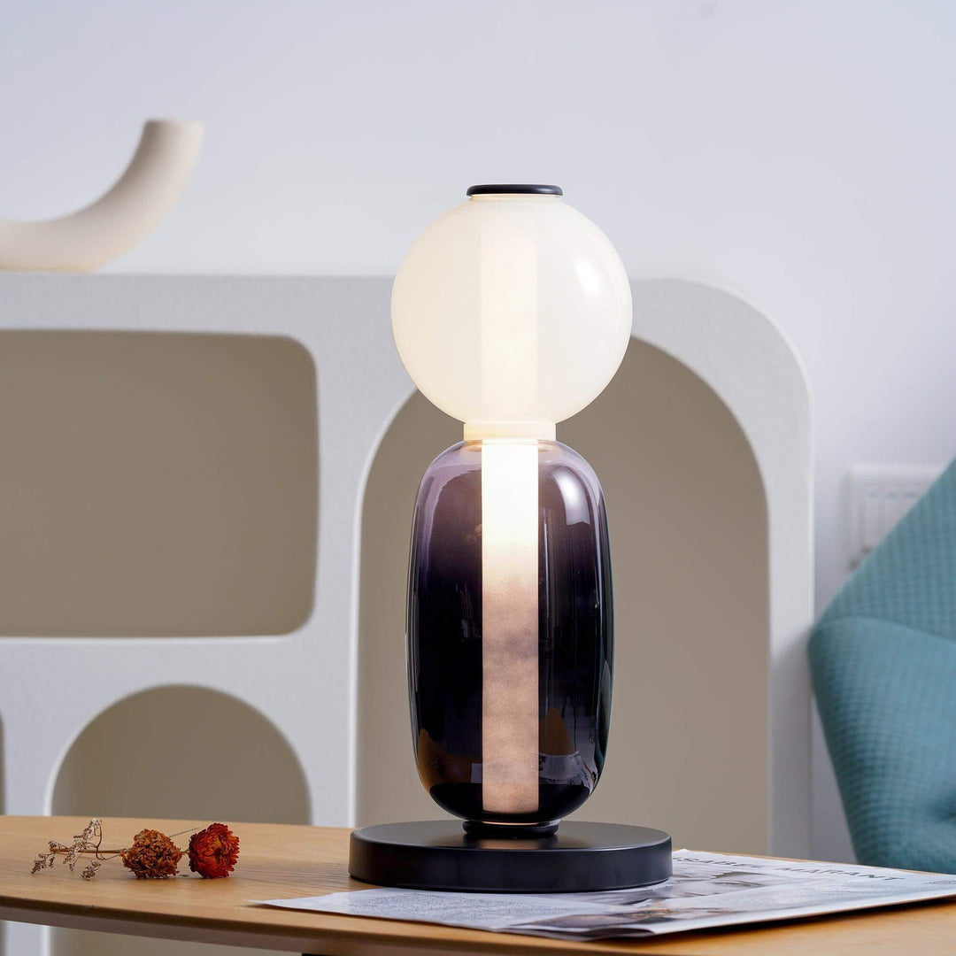 Candied Model A glass table lamp switched off, showing its frosted globe and smoky purple body
