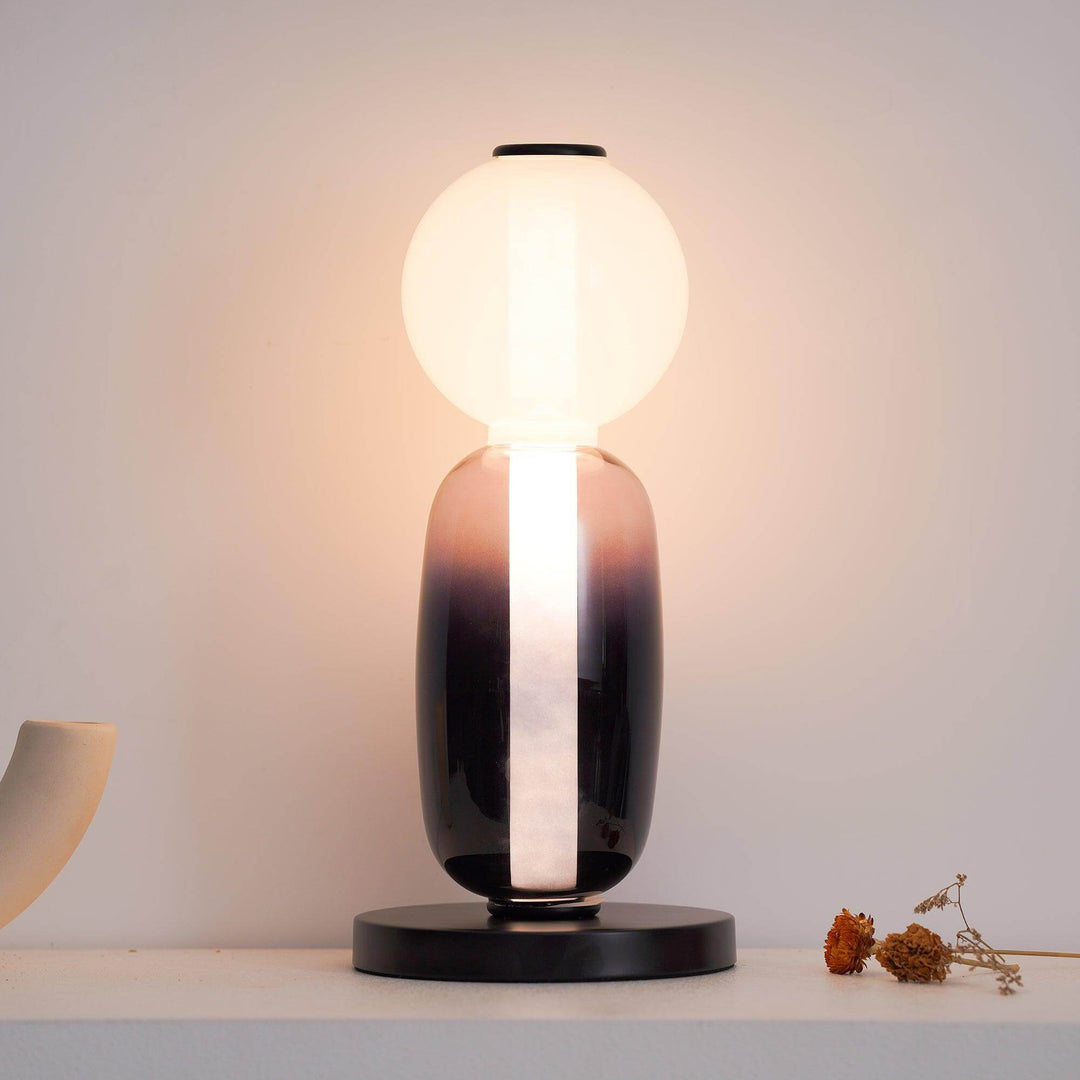 Smoked and frosted glass table lamp with spherical top, oval body and integrated vertical LED