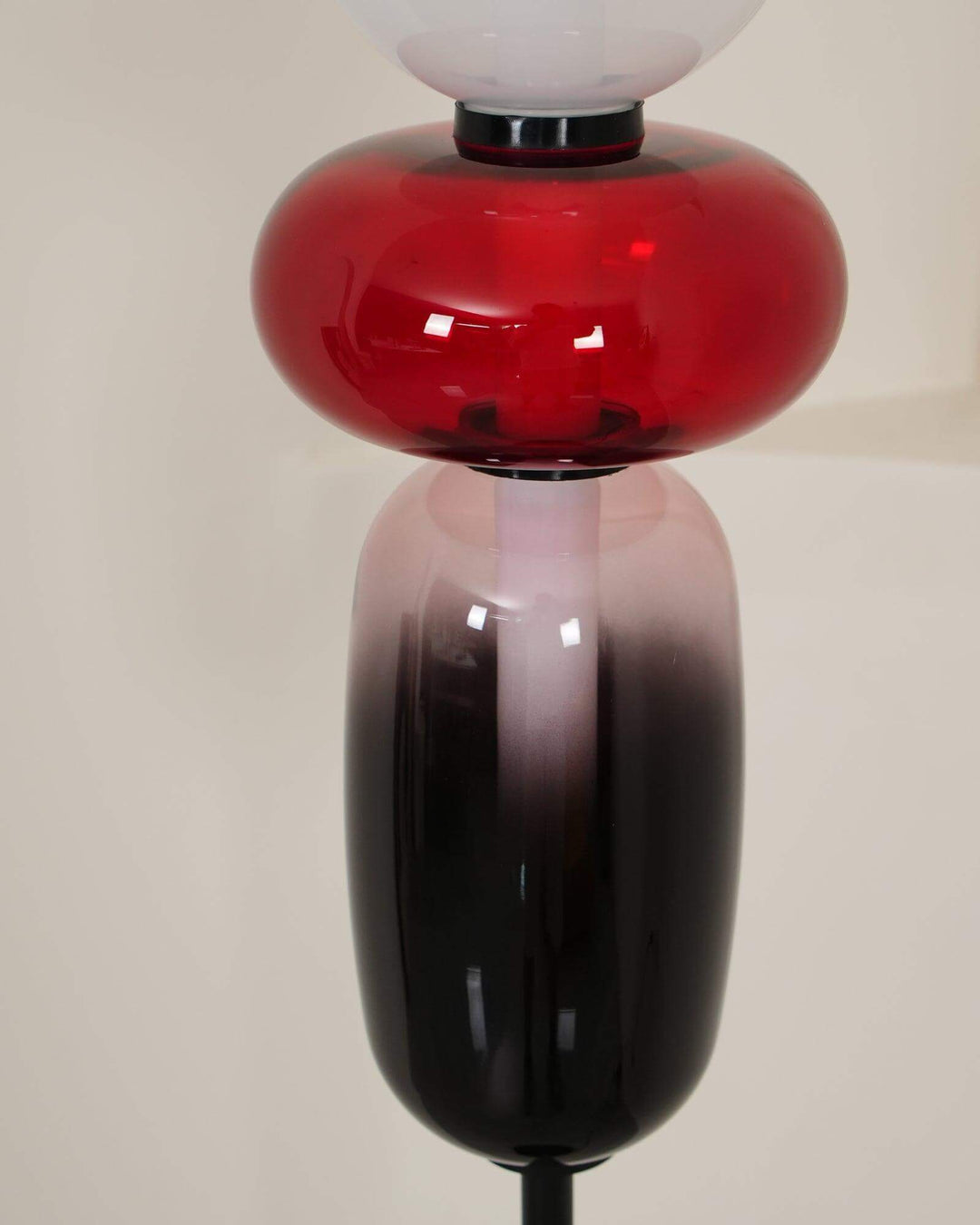 Close-up of the unlit red oval and smoky elongated glass shades on the Candied floor lamp.