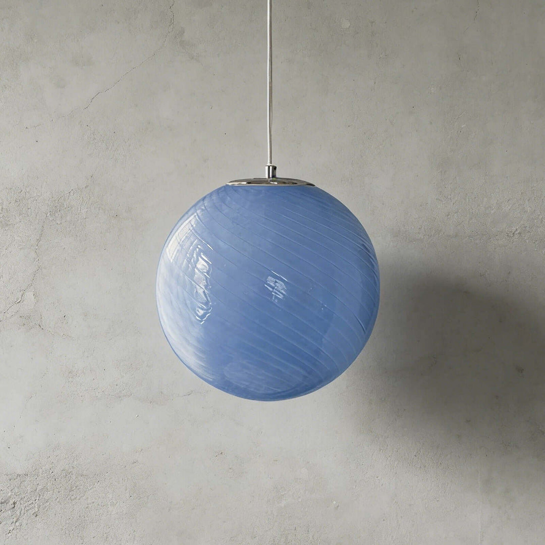 Blue Candy ribbed glass pendant light shown against a textured gray wall.
