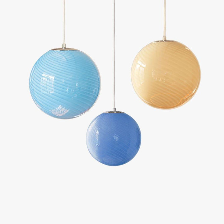 Candy Glass Pendant Light shown in light blue, blue, and yellow ribbed glass color options.