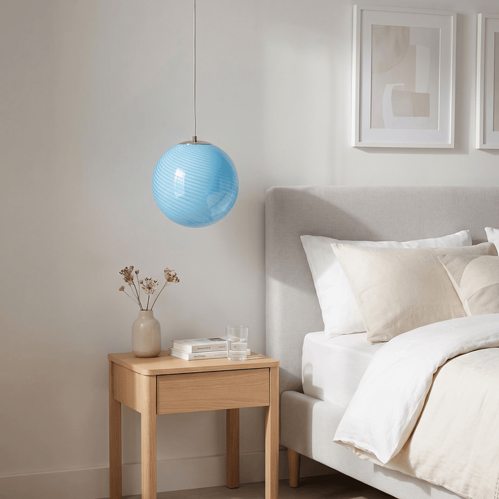 Light blue Candy Glass Pendant Light beside a bed as a modern bedroom hanging light.