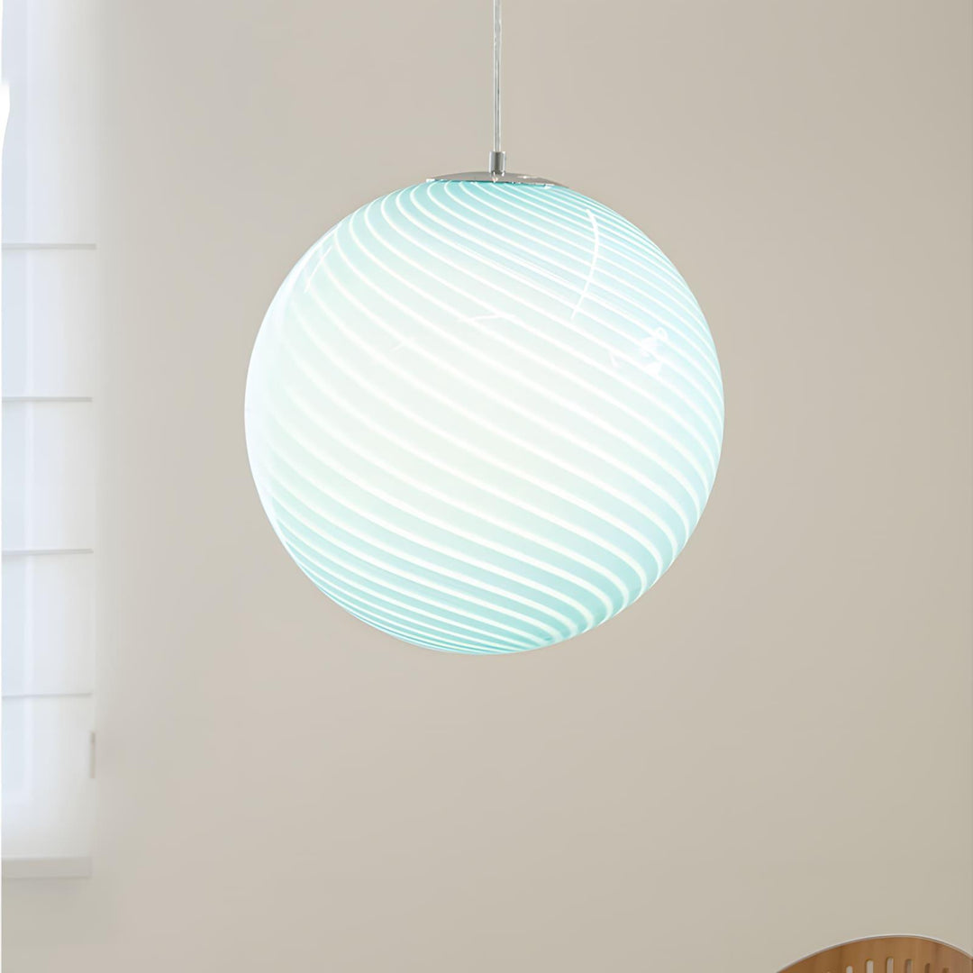 Close-up of an illuminated light blue Candy Glass Pendant Light with spiral ribbed texture.