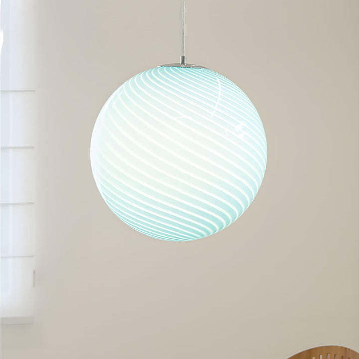 Close-up of an illuminated light blue Candy Glass Pendant Light with spiral ribbed texture.