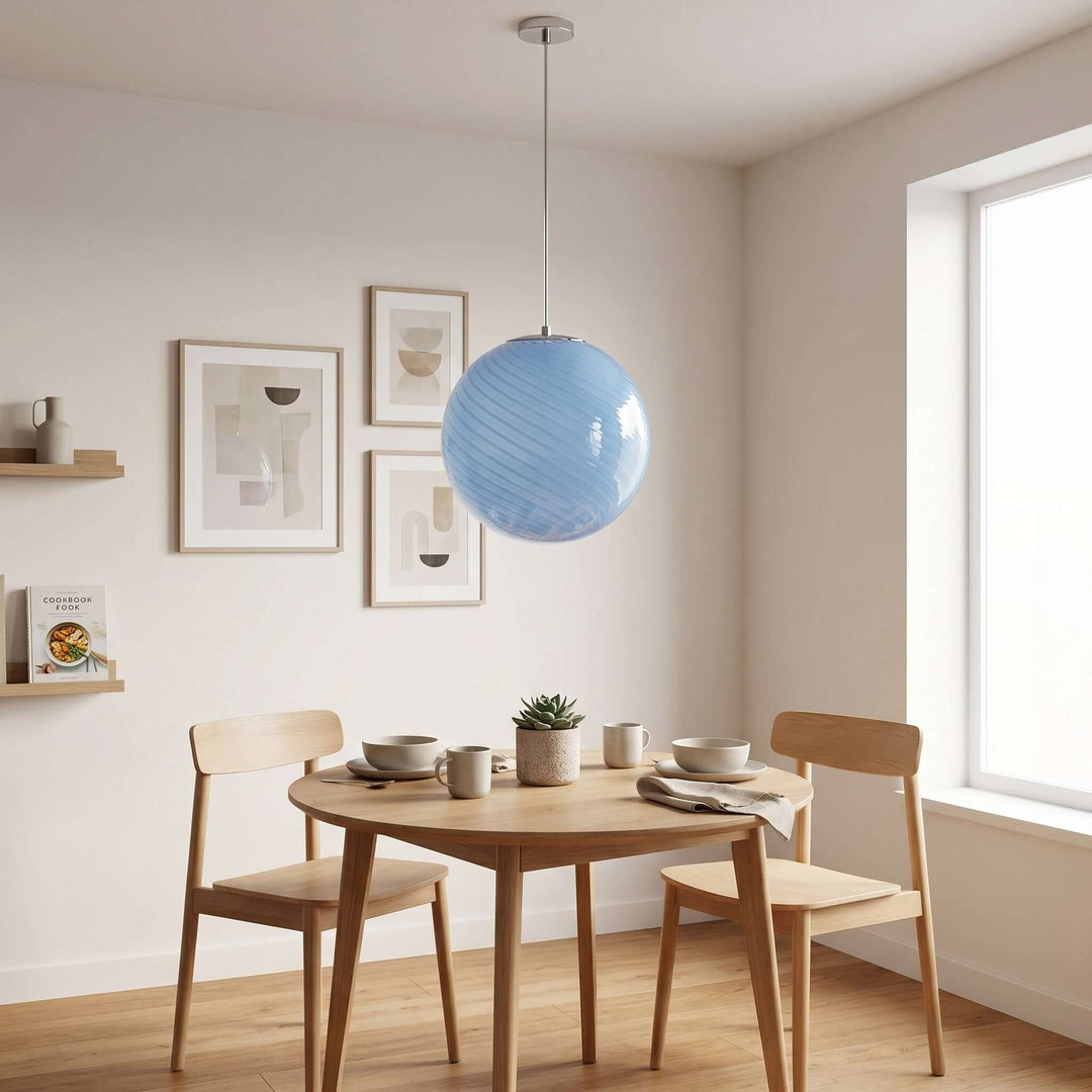 Light blue Candy Glass Pendant Light above a round dining table in a bright modern dining nook.