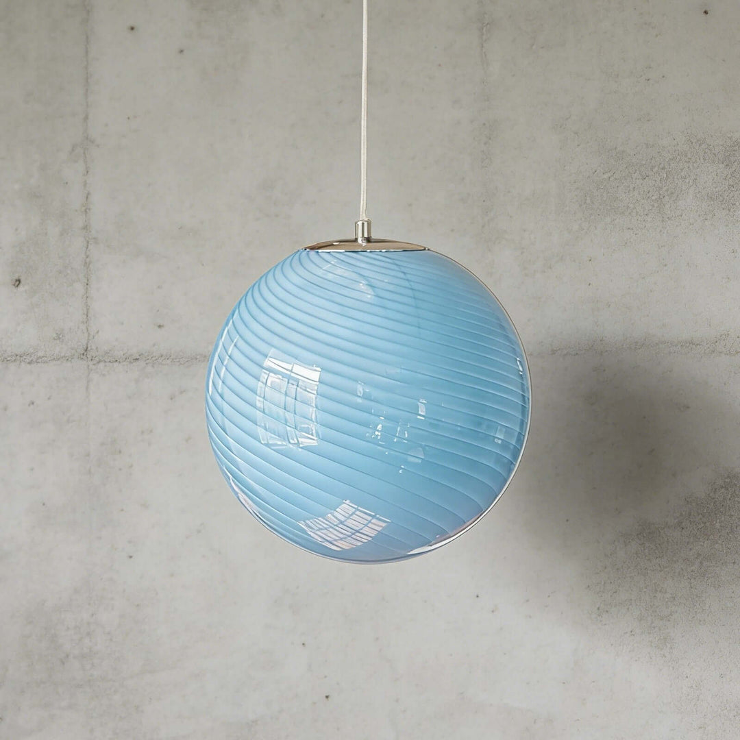 Light blue Candy ribbed glass pendant light shown against a textured gray wall.