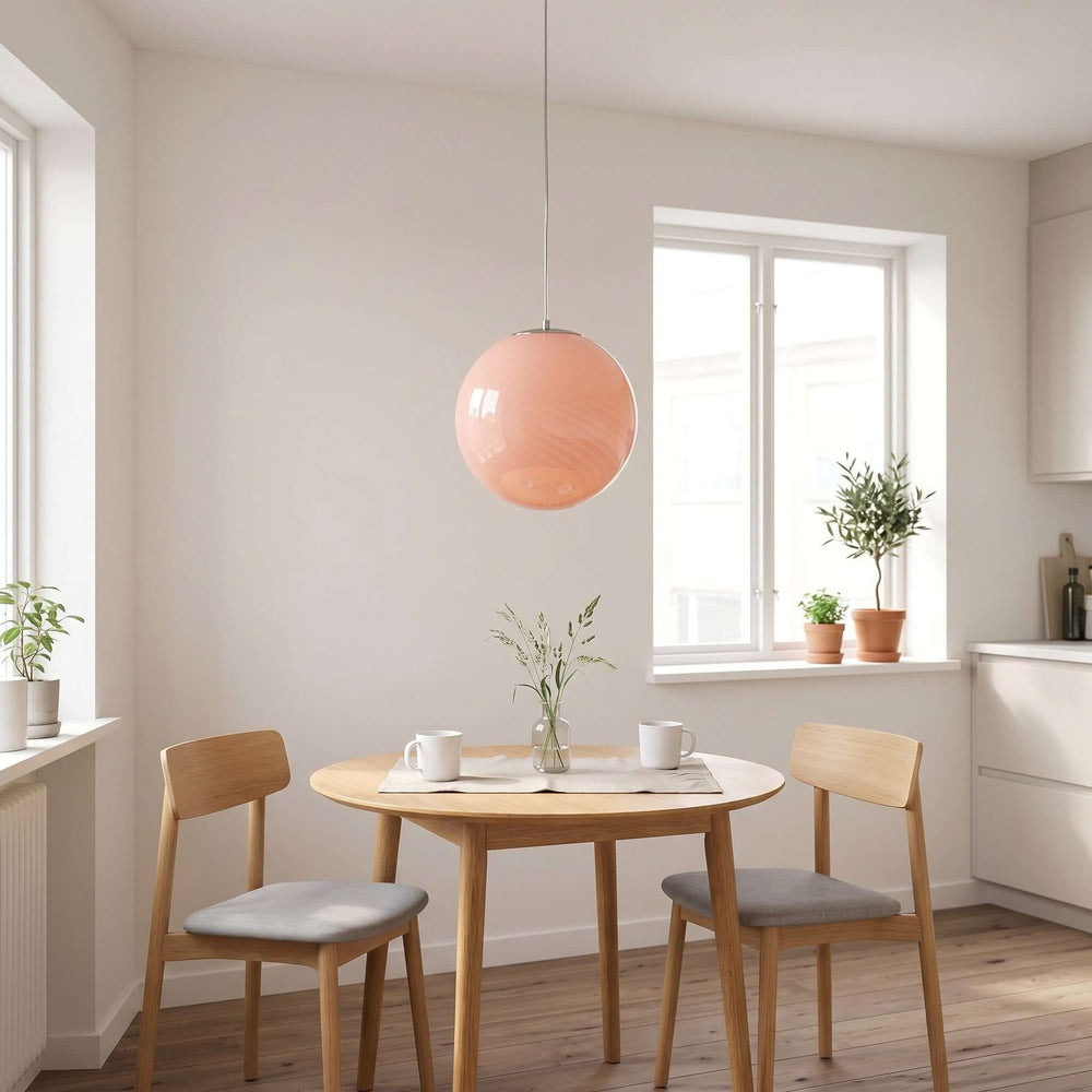 Pink Candy Glass Pendant Light hanging above a small breakfast nook table in a bright modern kitchen.