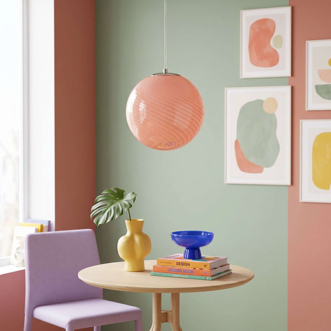 Pink Candy Glass Pendant Light above a small dining table in a colorful modern dining room.