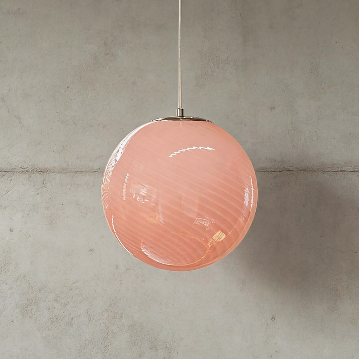 Pink Candy ribbed glass pendant light shown against a textured gray wall.