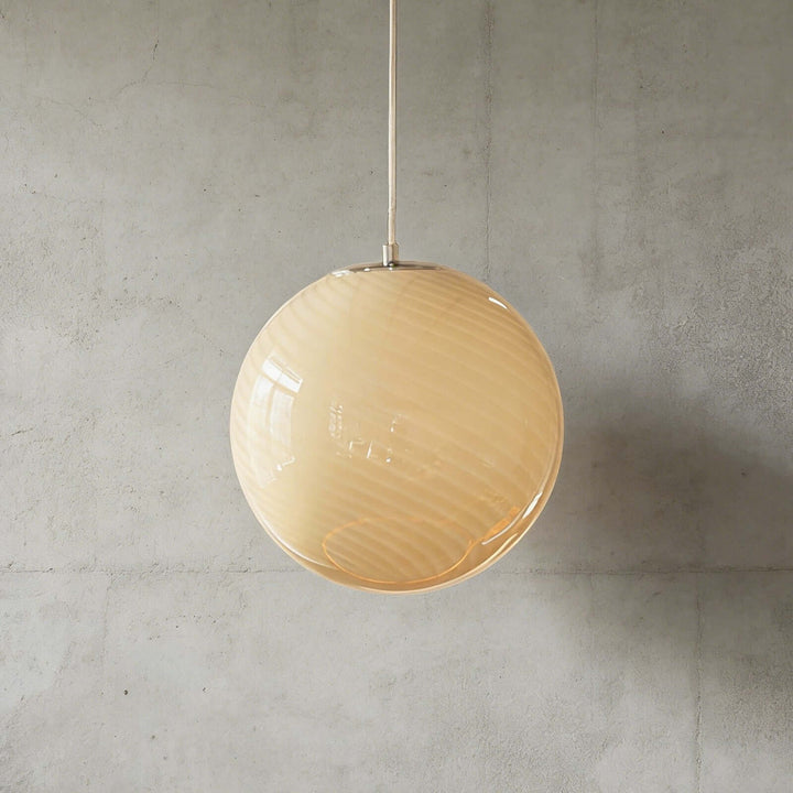Yellow Candy ribbed glass pendant light shown against a textured gray wall.