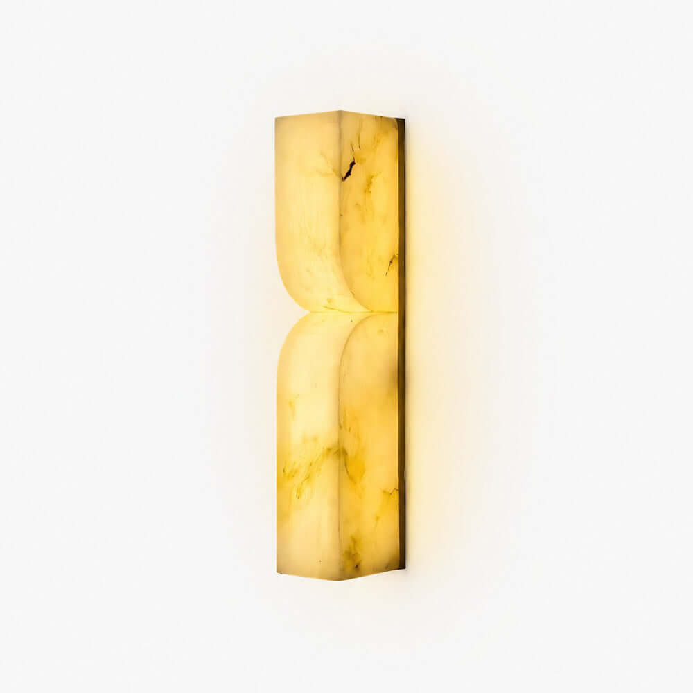 Cavira Wall Sconce in Spanish alabaster with a sculptural curved profile and warm integrated LED glow
