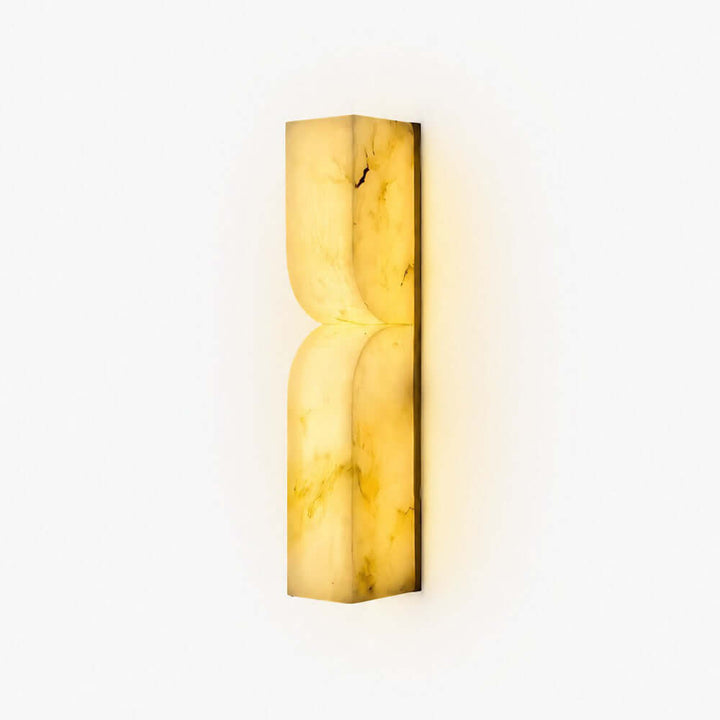 Cavira Wall Sconce in Spanish alabaster with a sculptural curved profile and warm integrated LED glow
