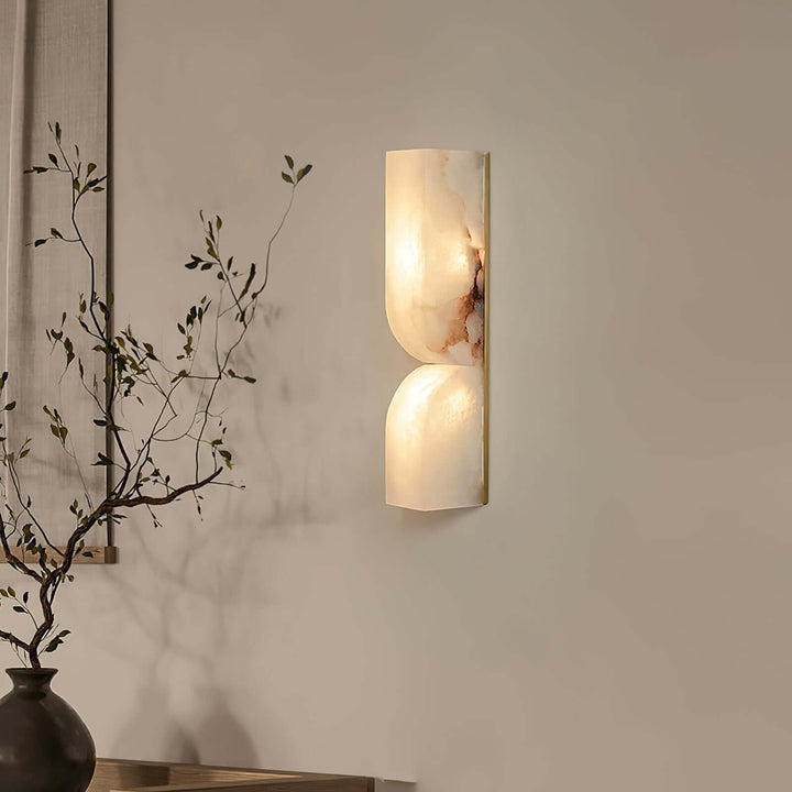Cavira Wall Sconce with warm light revealing the unique reddish veining of natural Spanish alabaster