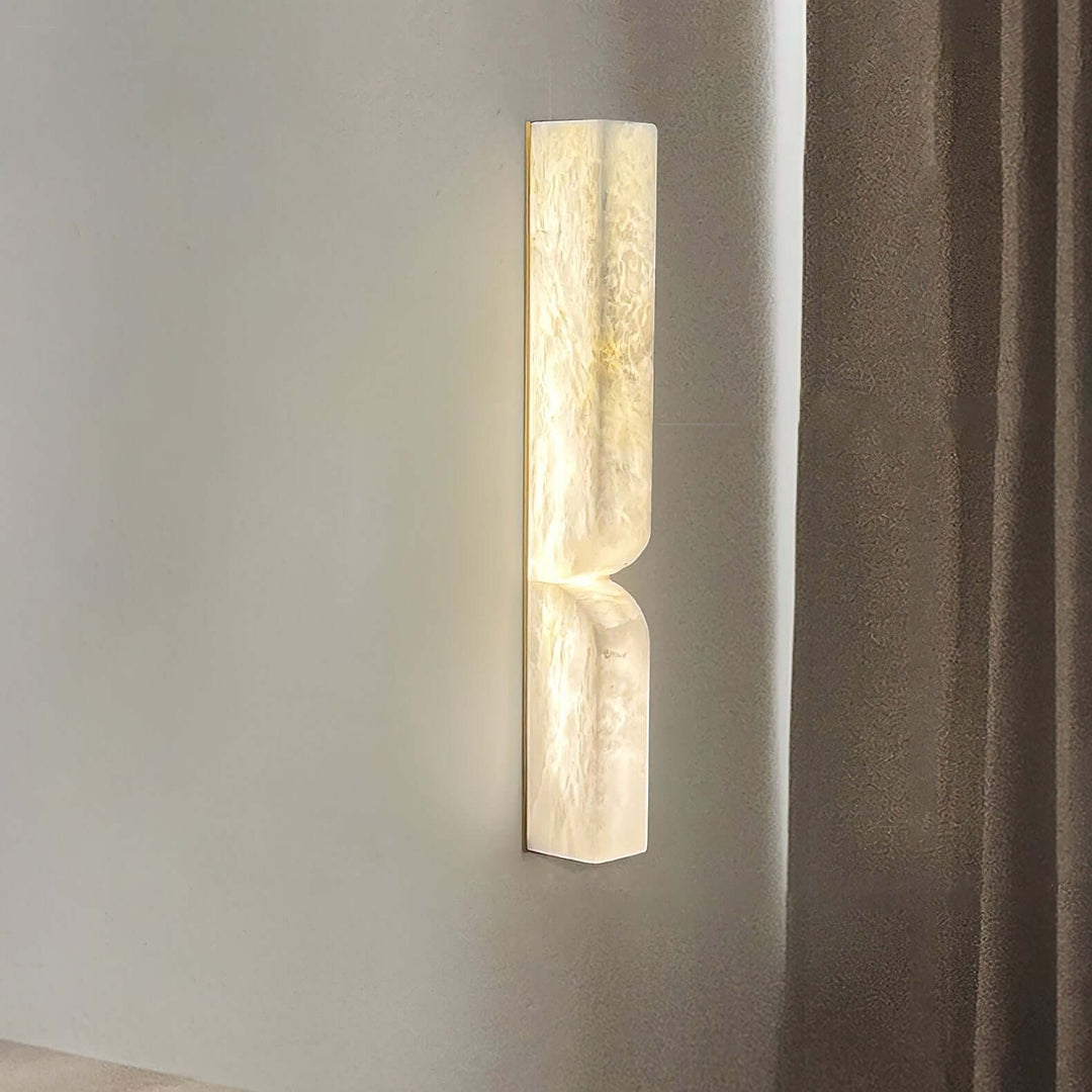 Close view of the Cavira Wall Sconce highlighting its translucent alabaster texture and warm LED light