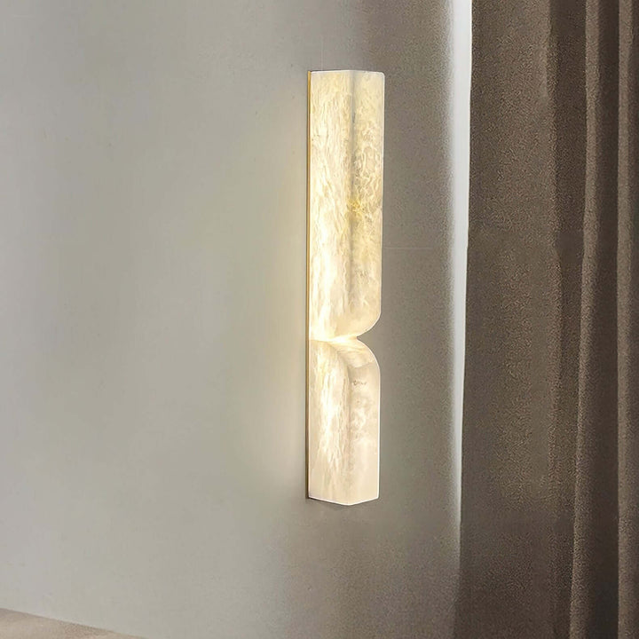 Close view of the Cavira Wall Sconce highlighting its translucent alabaster texture and warm LED light
