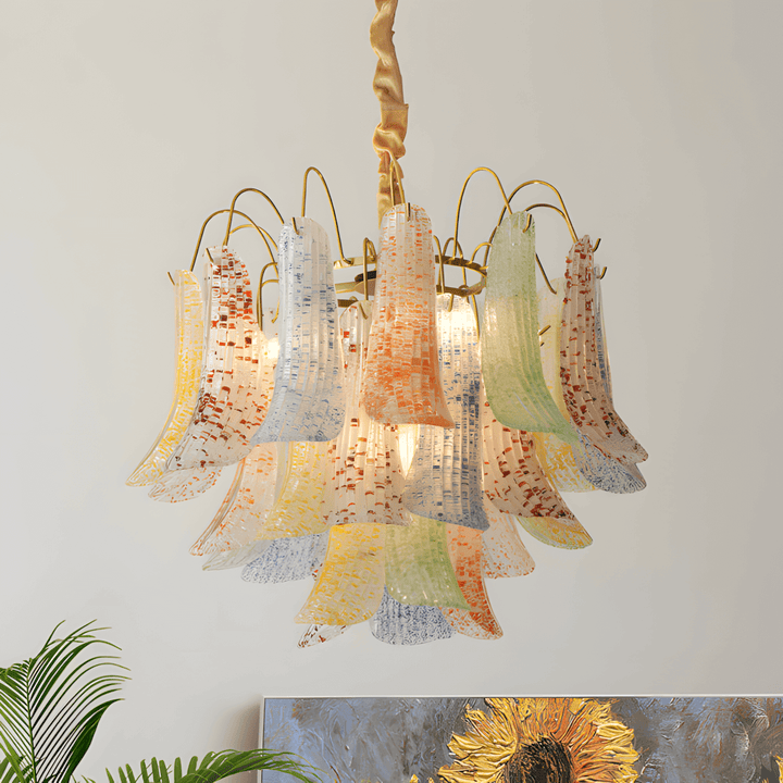 Colorful Murano glass chandelier glowing above sunflower artwork and indoor plants