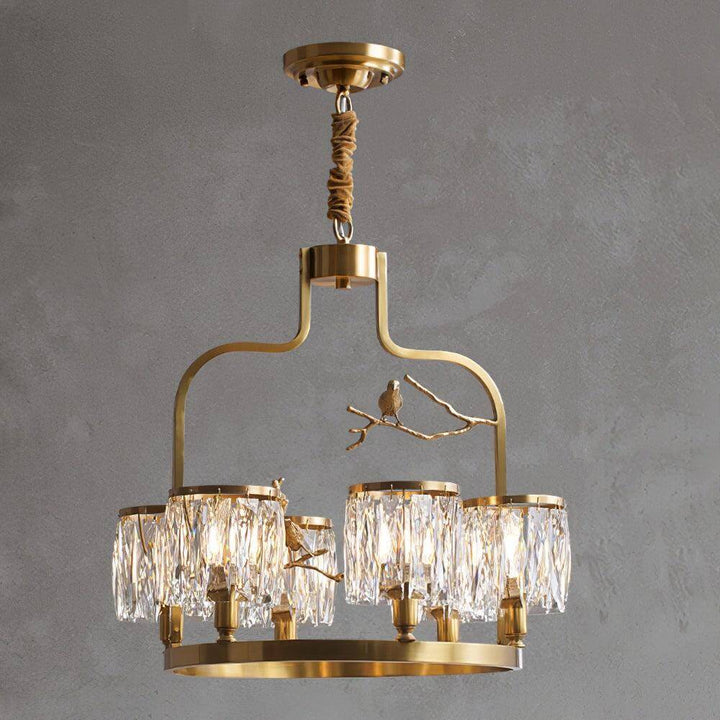 Close-up of the sculpted brass bird and branch ornament featured on the Crystal Bird Chandelier
