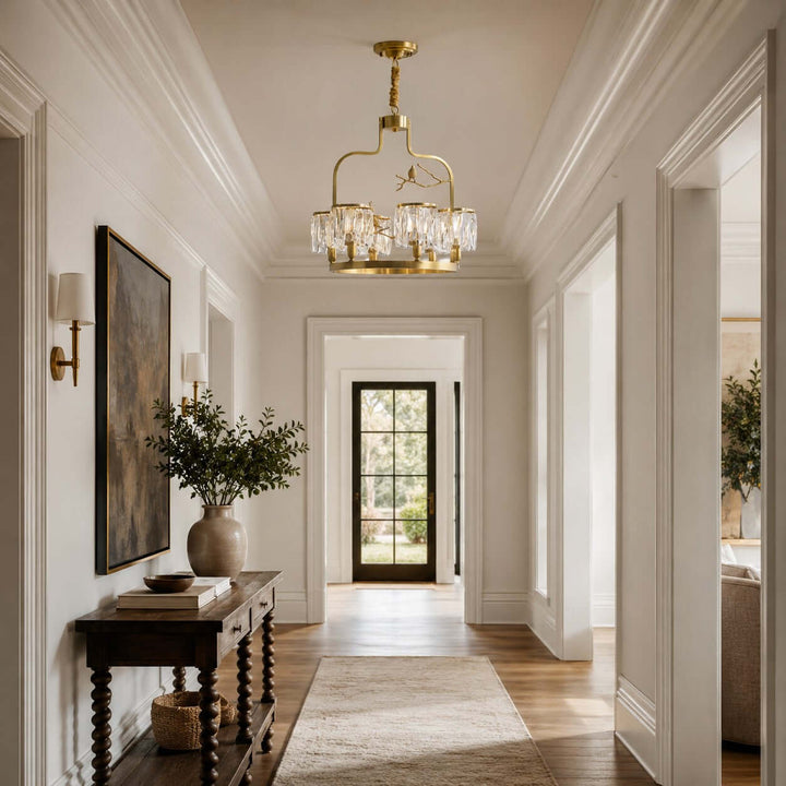 Brass Crystal Bird Chandelier lighting a neutral hallway with wood floors and classic wall molding
