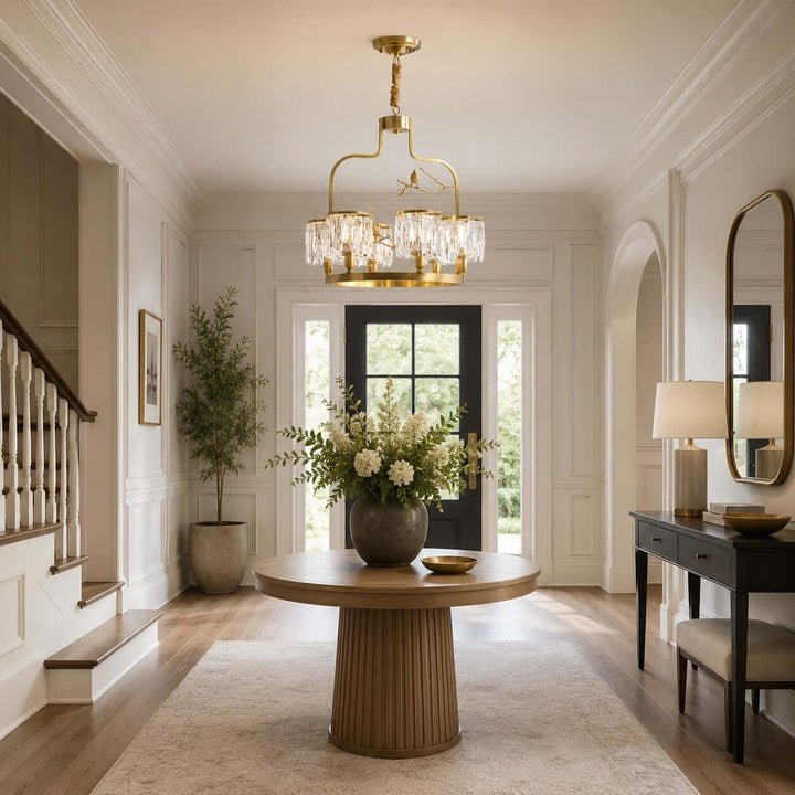 Crystal Bird Chandelier centered above a round wood table in a bright foyer beside the staircase