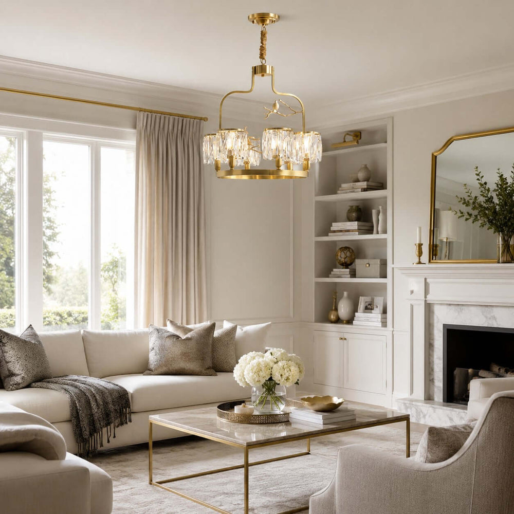 Crystal Bird Chandelier hanging in a bright neutral living room with a fireplace and large windows
