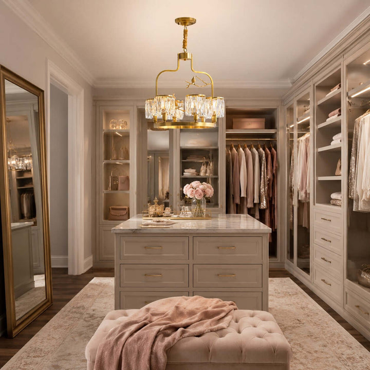 Crystal Bird Chandelier illuminating a warm walk-in closet with built-in wardrobes and a center island
