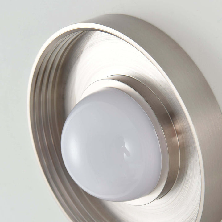 Close-up of the Dimple wall sconce metal backplate and dome light module.