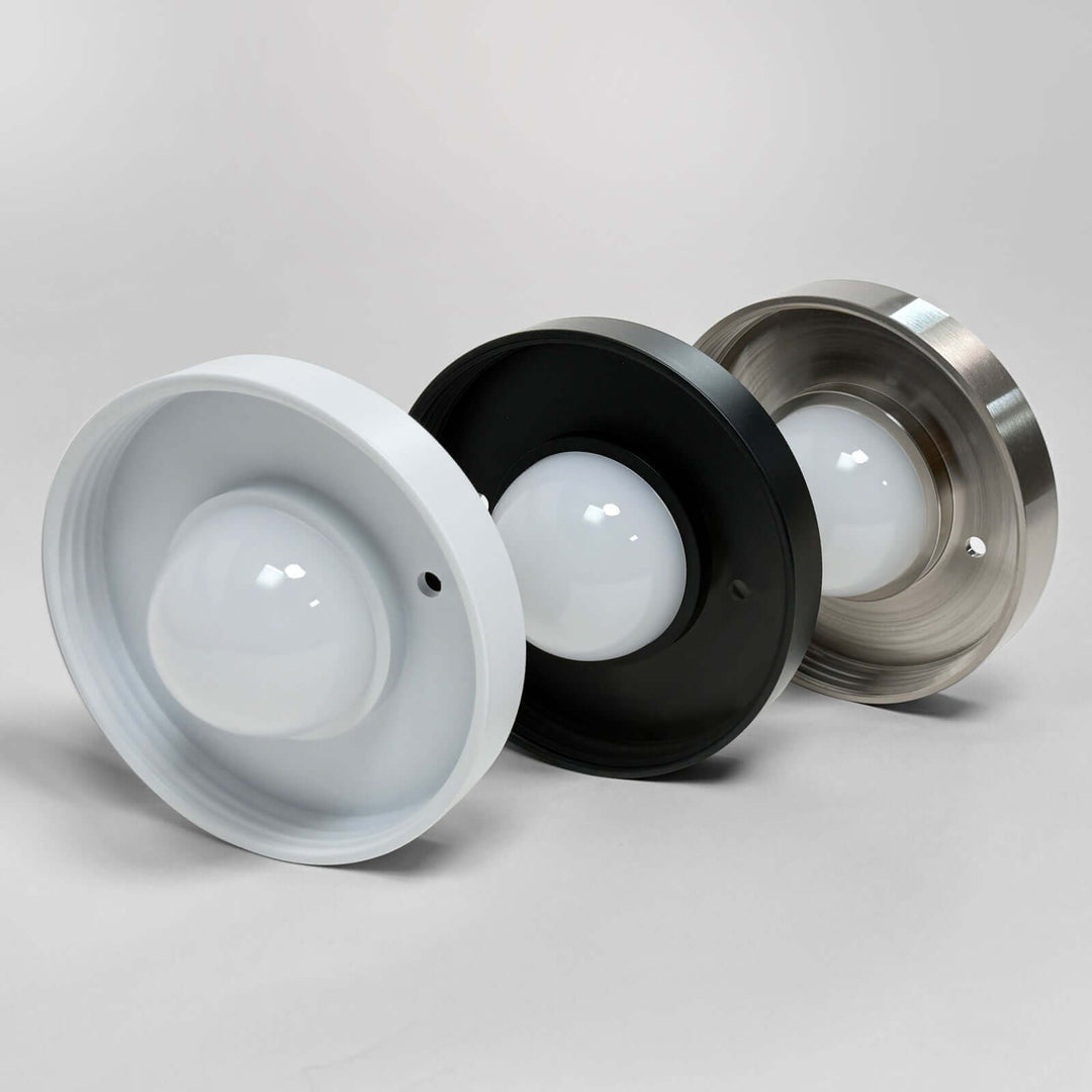 Stacked white, black, and nickel backplates showing finish colors.