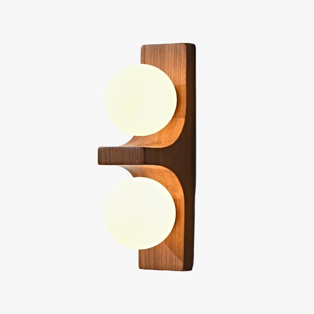 Eveline double wall sconce in dark wood with two glowing white glass globes on a white background