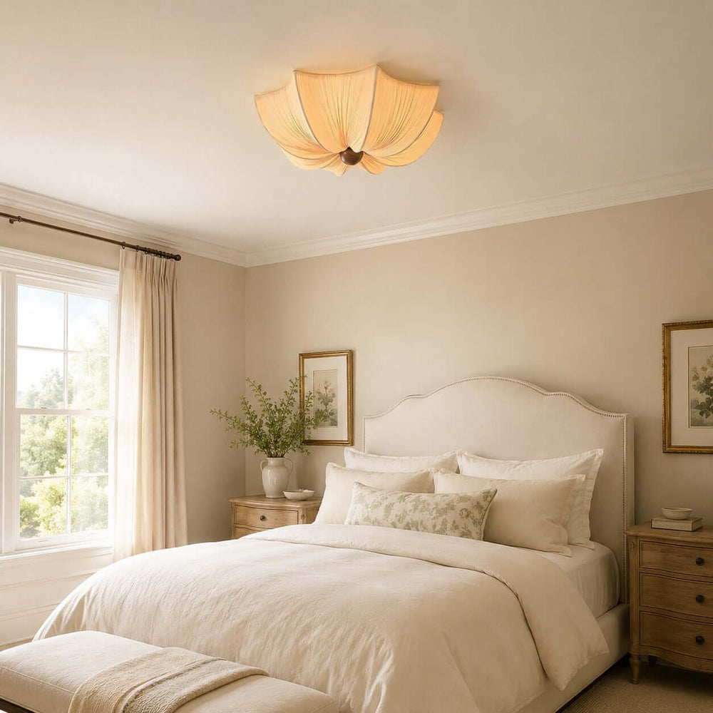 Warm fabric flush mount ceiling light installed above a neutral French-style bedroom