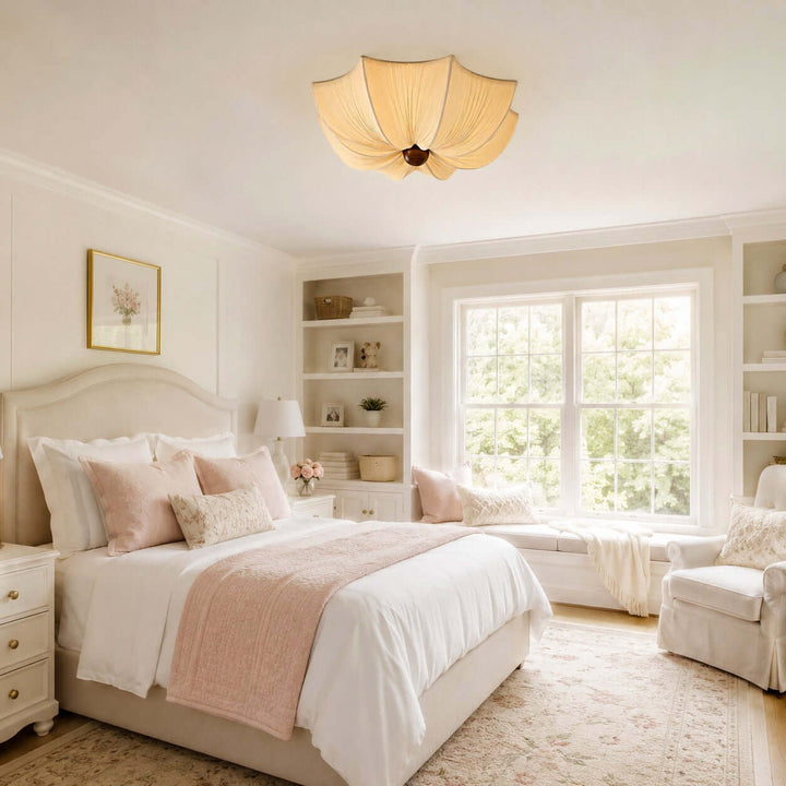 Flower-shaped fabric ceiling light illuminating a bright bedroom with soft pink accents
