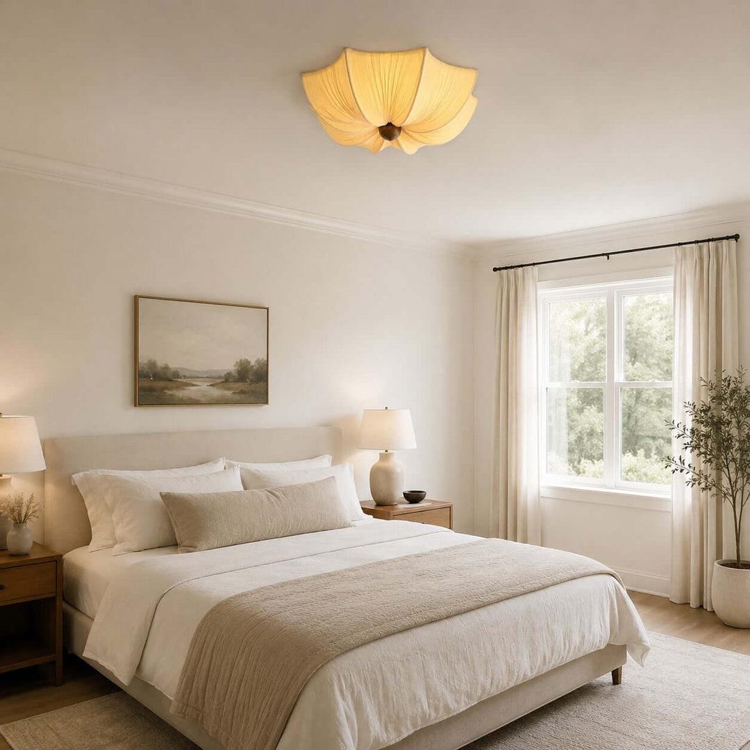 Low-profile fabric ceiling light above a spacious neutral bedroom with wood nightstands