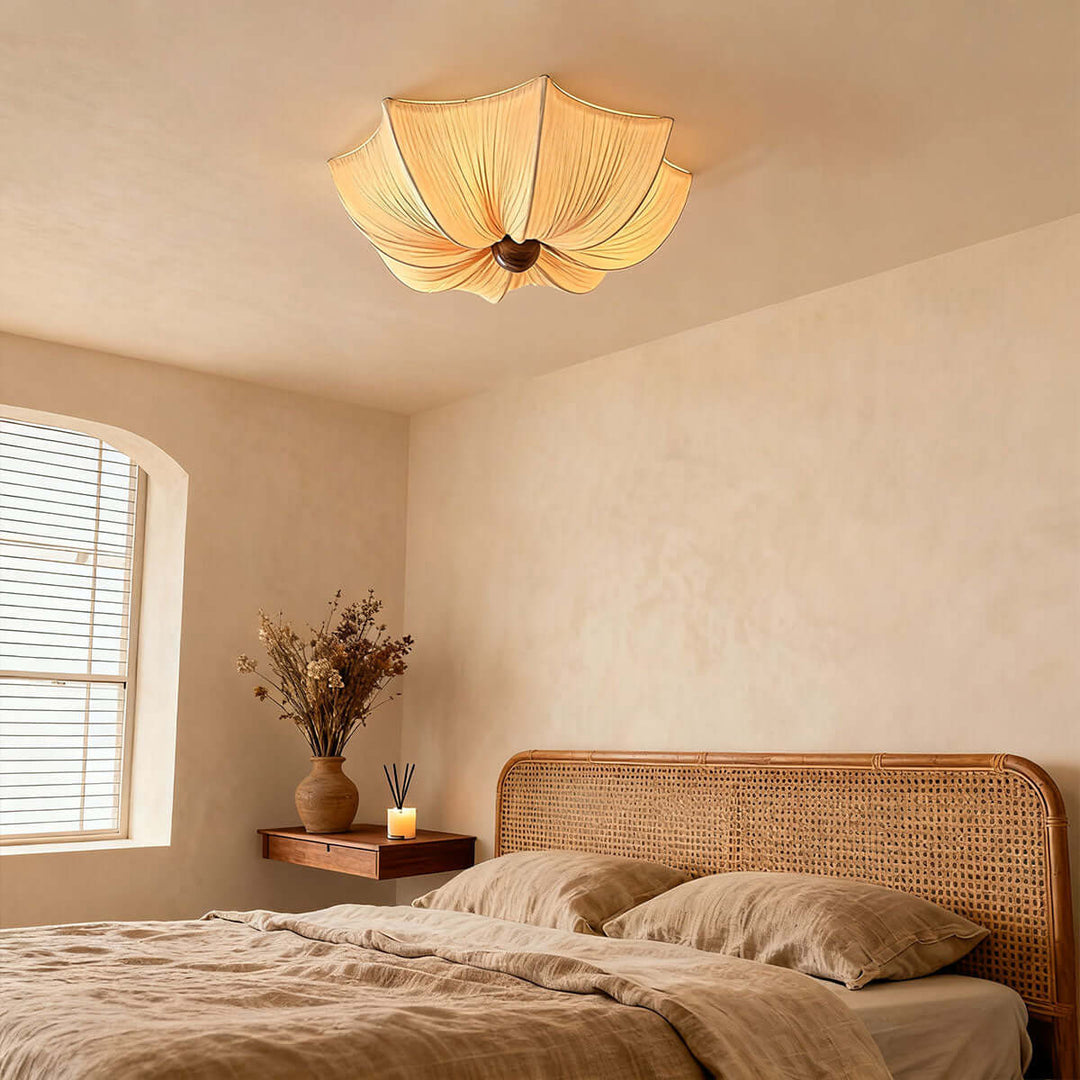 Flower-shaped fabric ceiling light above a rattan bed in a warm neutral bedroom