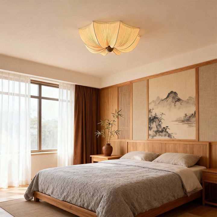 Warm fabric flush mount ceiling light above a natural wood bed in a calming bedroom