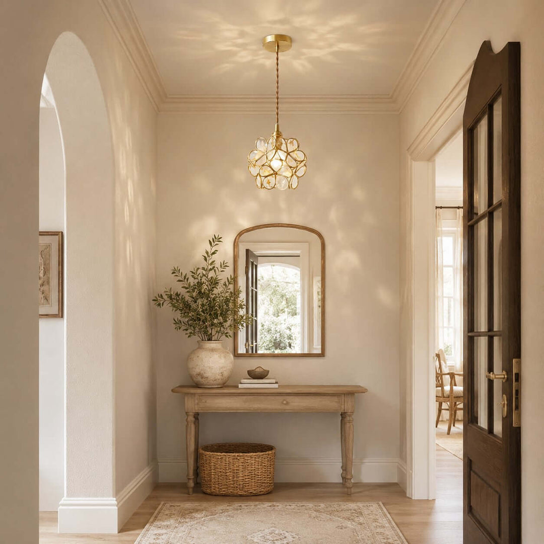 White glass petal pendant light casting decorative shadows in a warm entryway