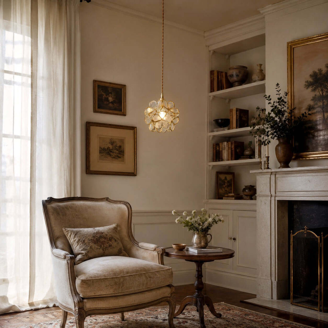 White glass petal pendant light illuminating a vintage living room reading corner