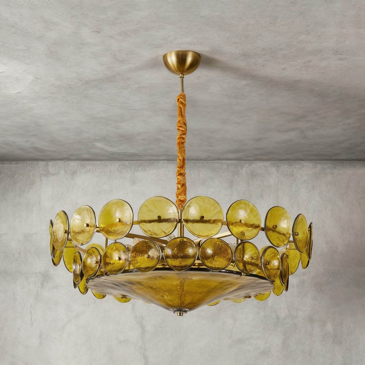 Low-angle view of a green glass chandelier with a large curved bottom diffuser