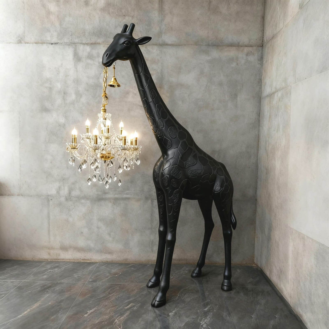 Large black and gold giraffe floor lamp with a glowing crystal chandelier