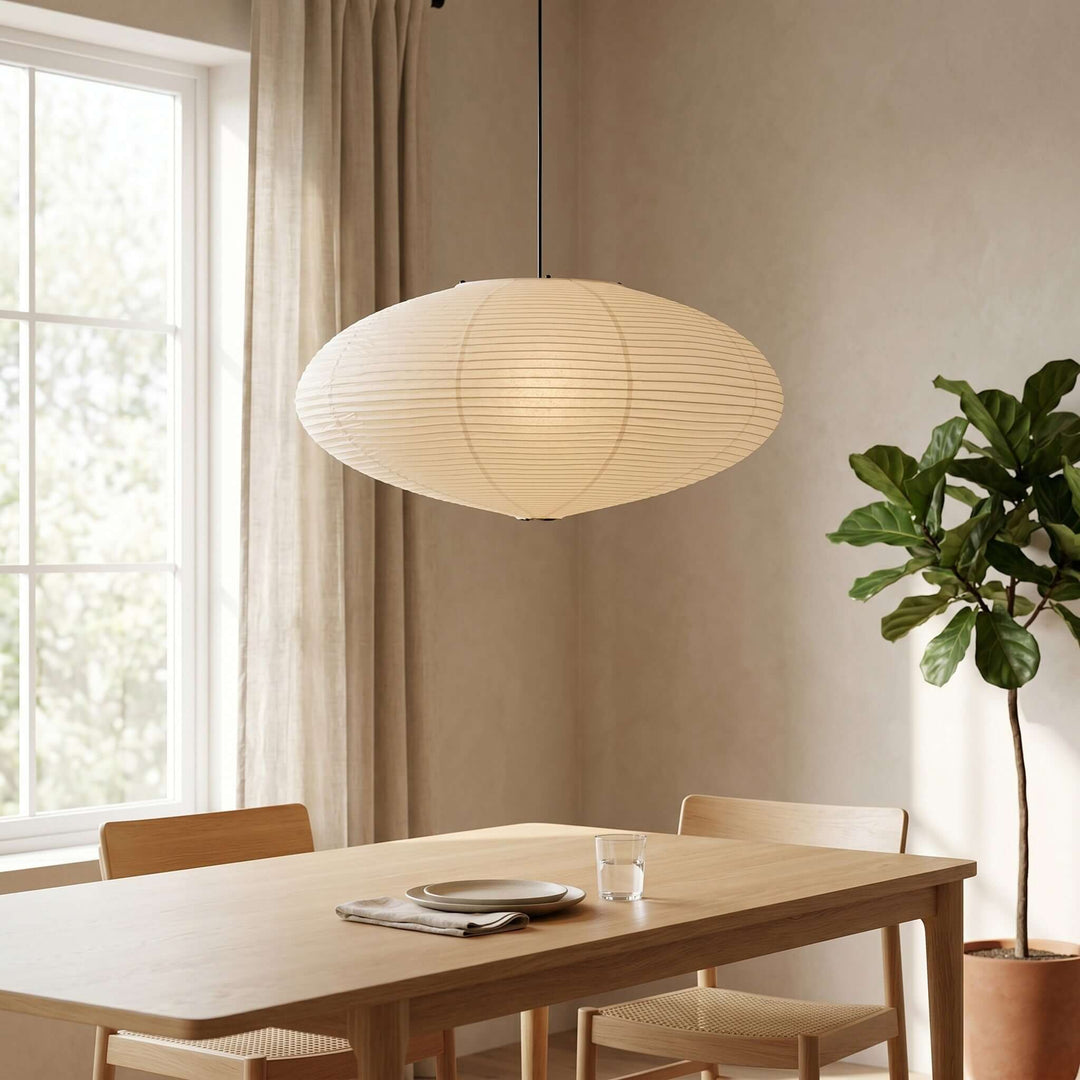 Large oval washi paper pendant light shown close over a dining table.