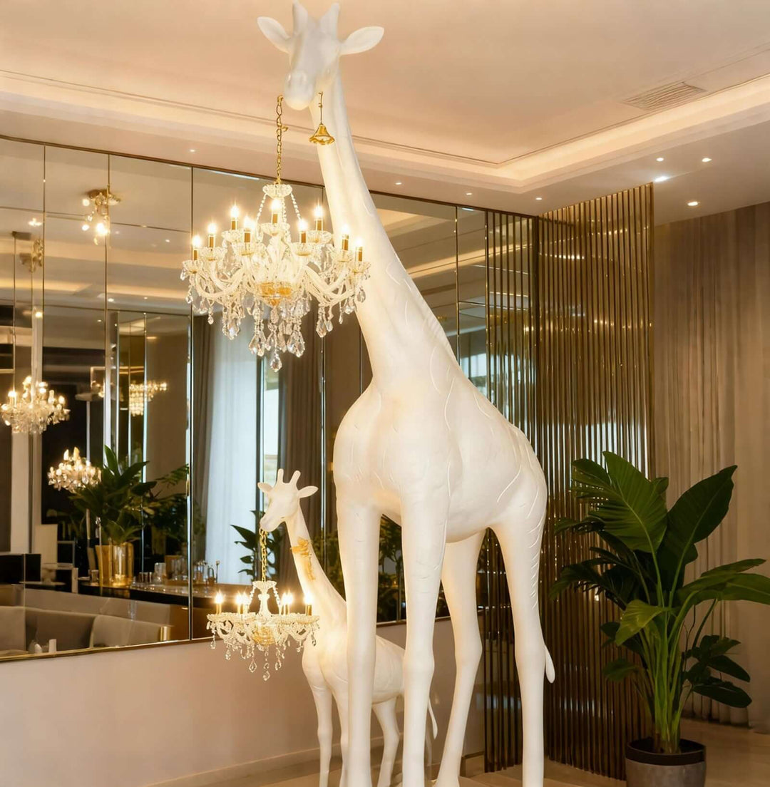 Large white giraffe floor lamps with crystal lights in a luxury lobby interior