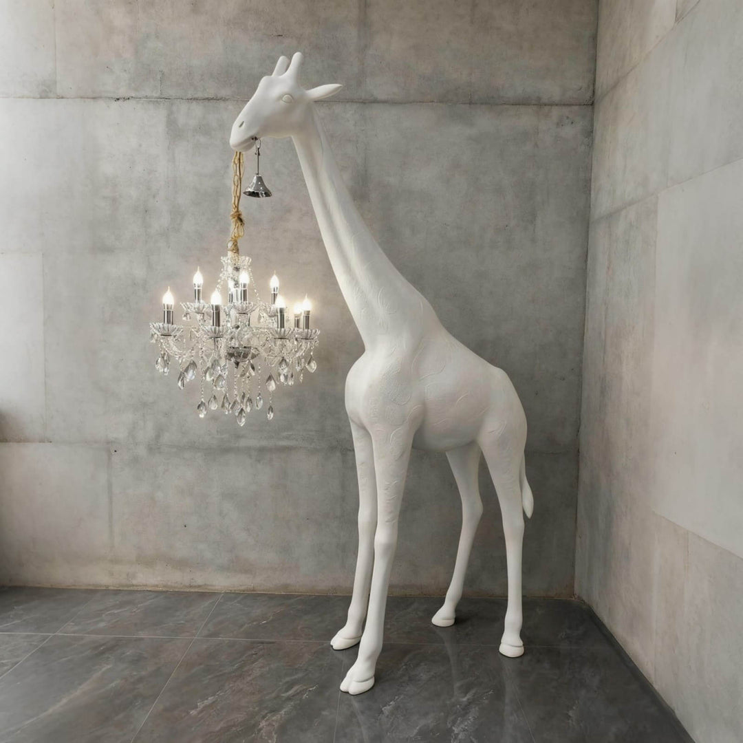 Large white and silver giraffe floor lamp displayed in a contemporary concrete interior