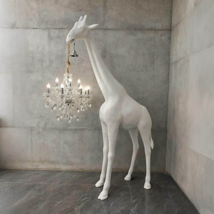 Large white and silver giraffe floor lamp displayed in a contemporary concrete interior