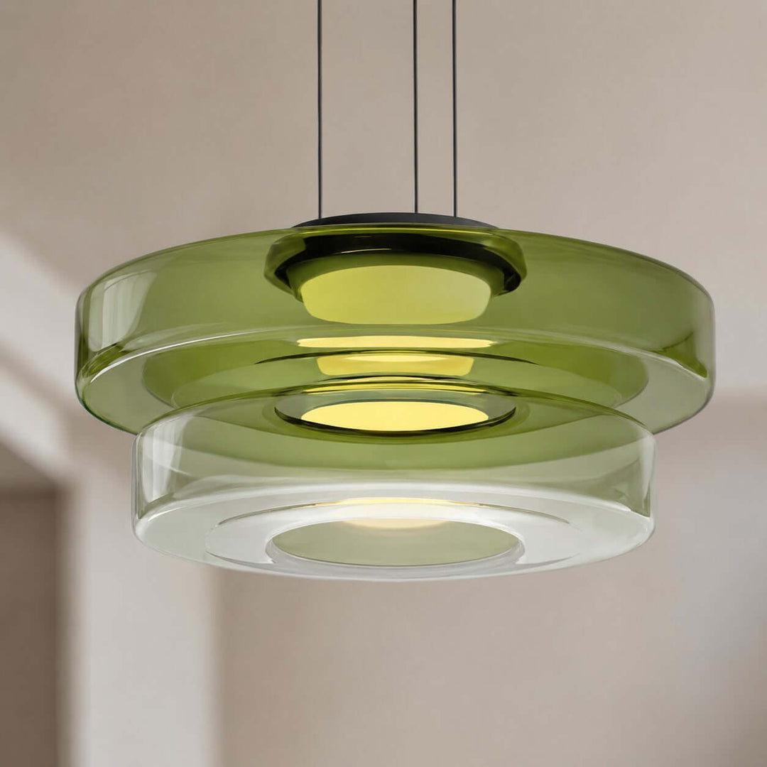 Close-up of a green two-layer glass pendant light with circular shades and integrated LED