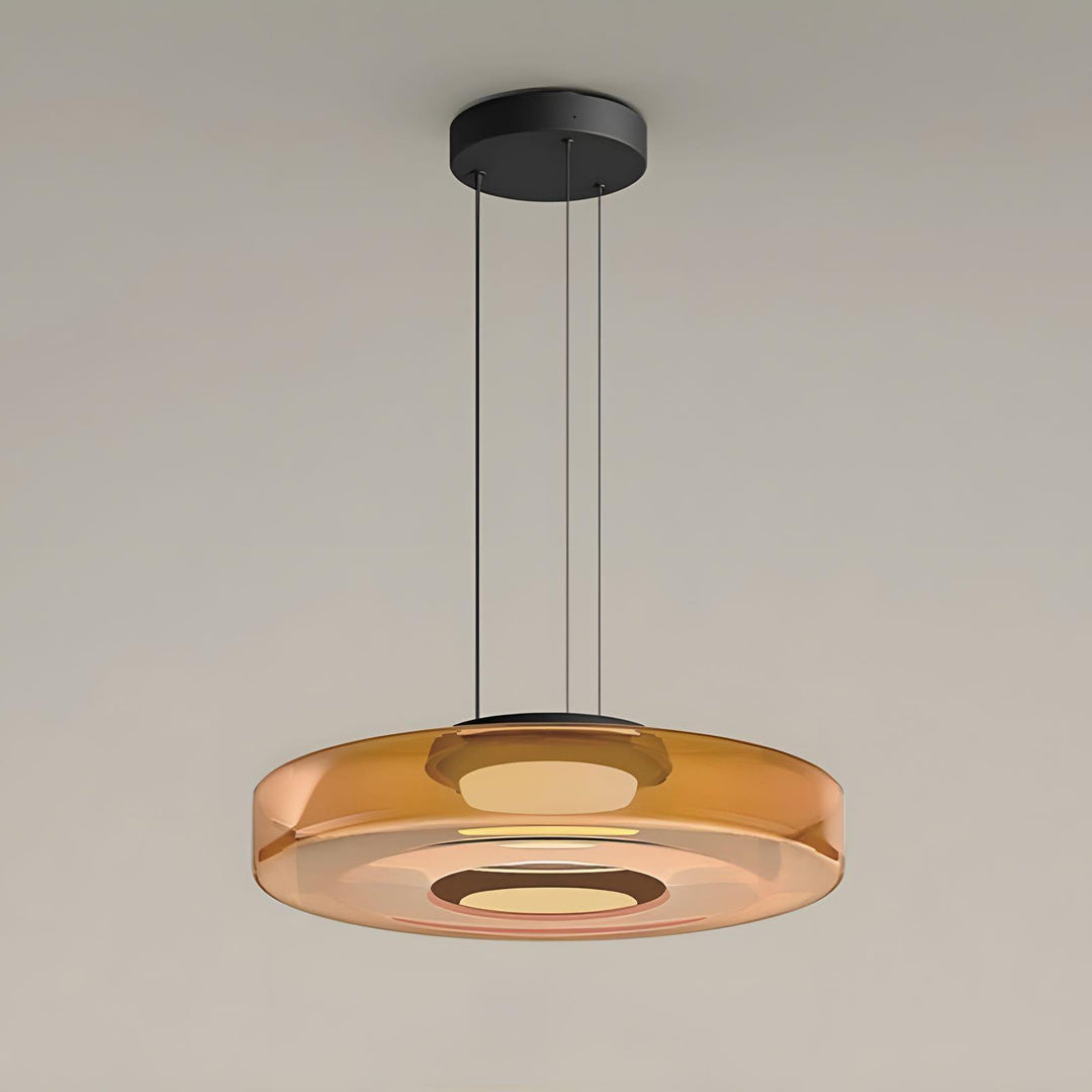 Orange one-layer glass pendant light with translucent disc shade and black ceiling mount