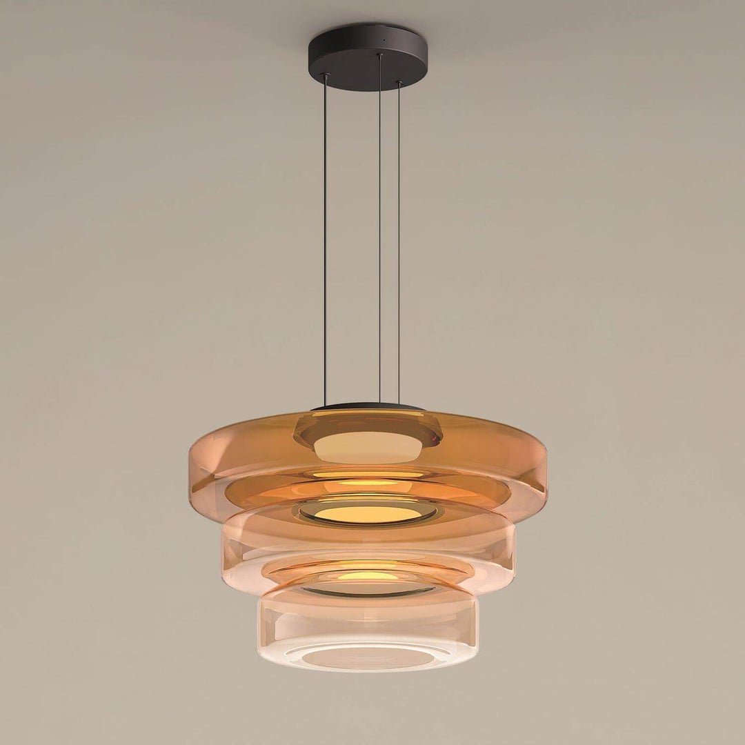 Orange three-layer glass pendant light with graduated circular shades and black ceiling canopy