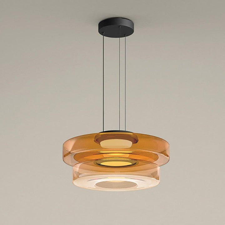 Orange two-layer glass pendant light with layered circular shades and warm integrated LED