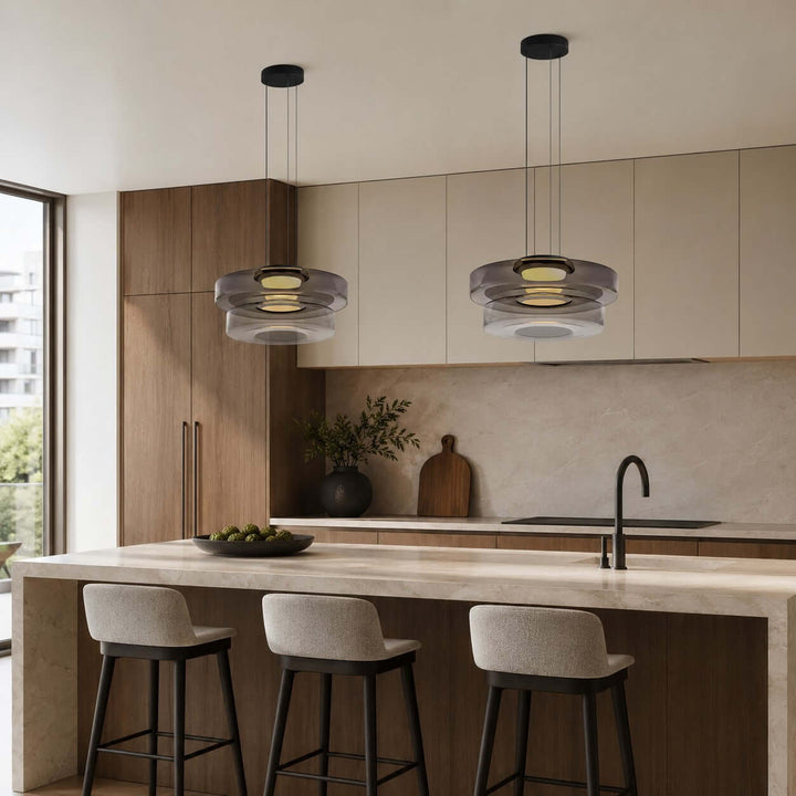 Pair of Smoke Grey three-layer glass pendant lights above a modern stone kitchen island