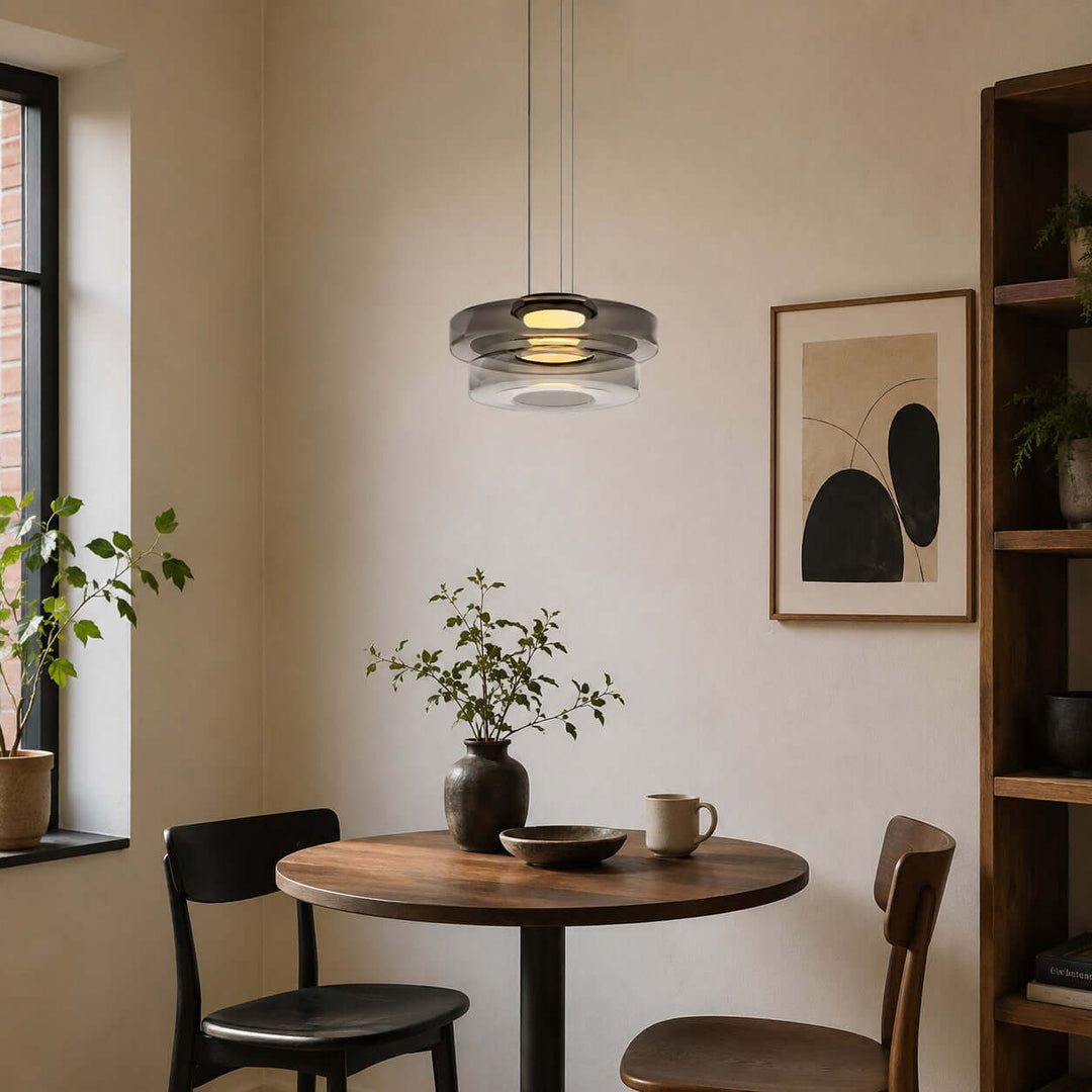 Smoke Grey two-layer glass pendant light above a small round dining table in a modern interior