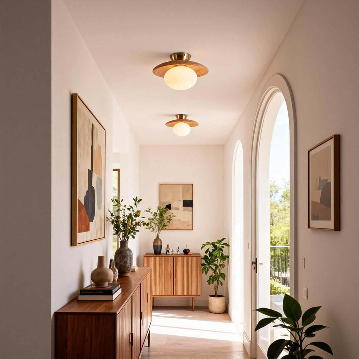 Two light wood flush mount ceiling lights in an arched entry hallway